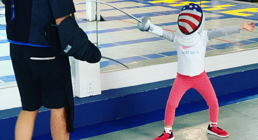 Young fencers aged 6-12 learning basic techniques in a fun, supportive summer camp environment