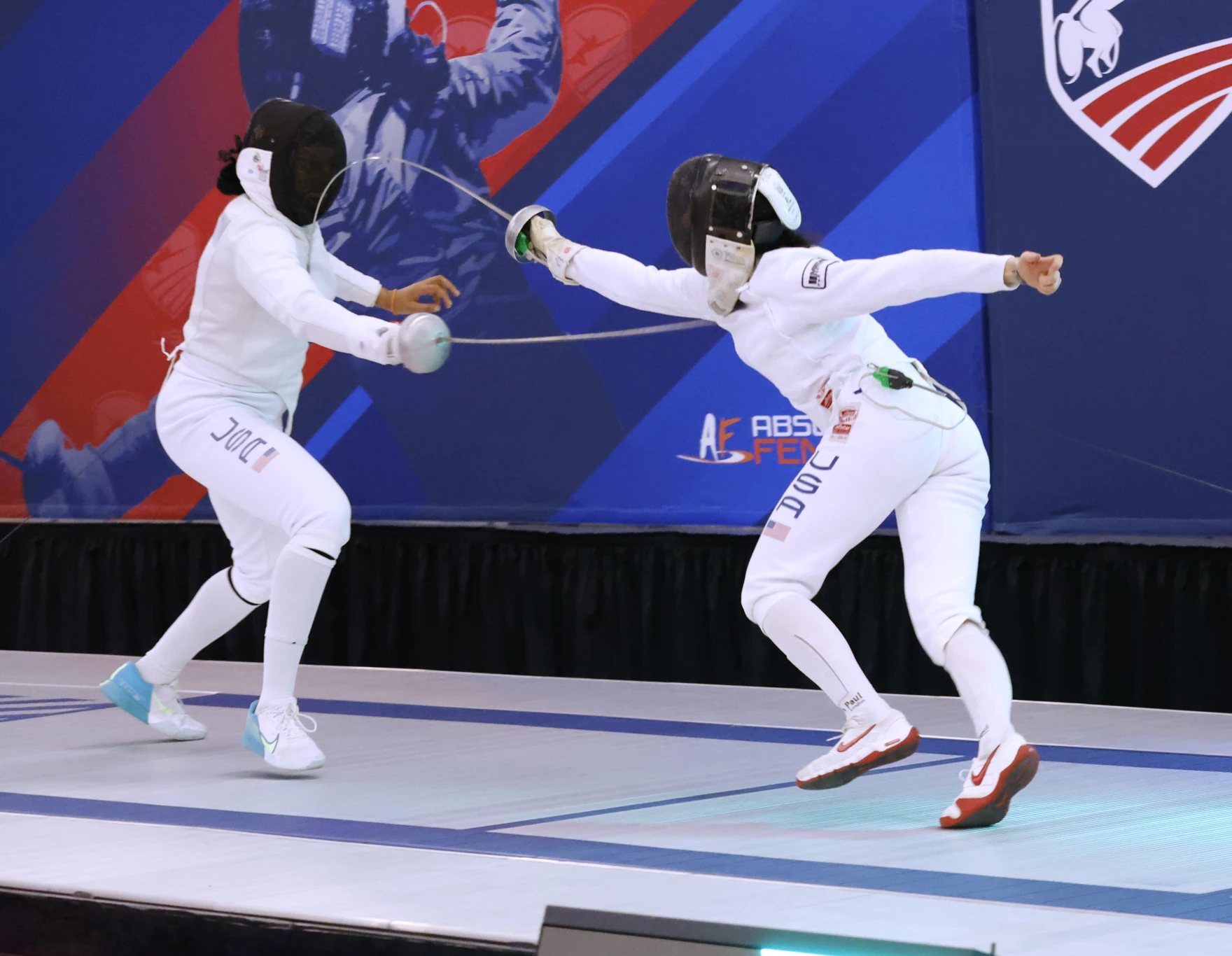 Advanced competitive fencers practicing intensive techniques in preparation for Summer National Championships