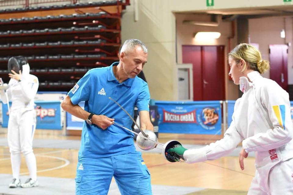 Coach Yuriy Mazur demonstrating fencing technique with student in training session